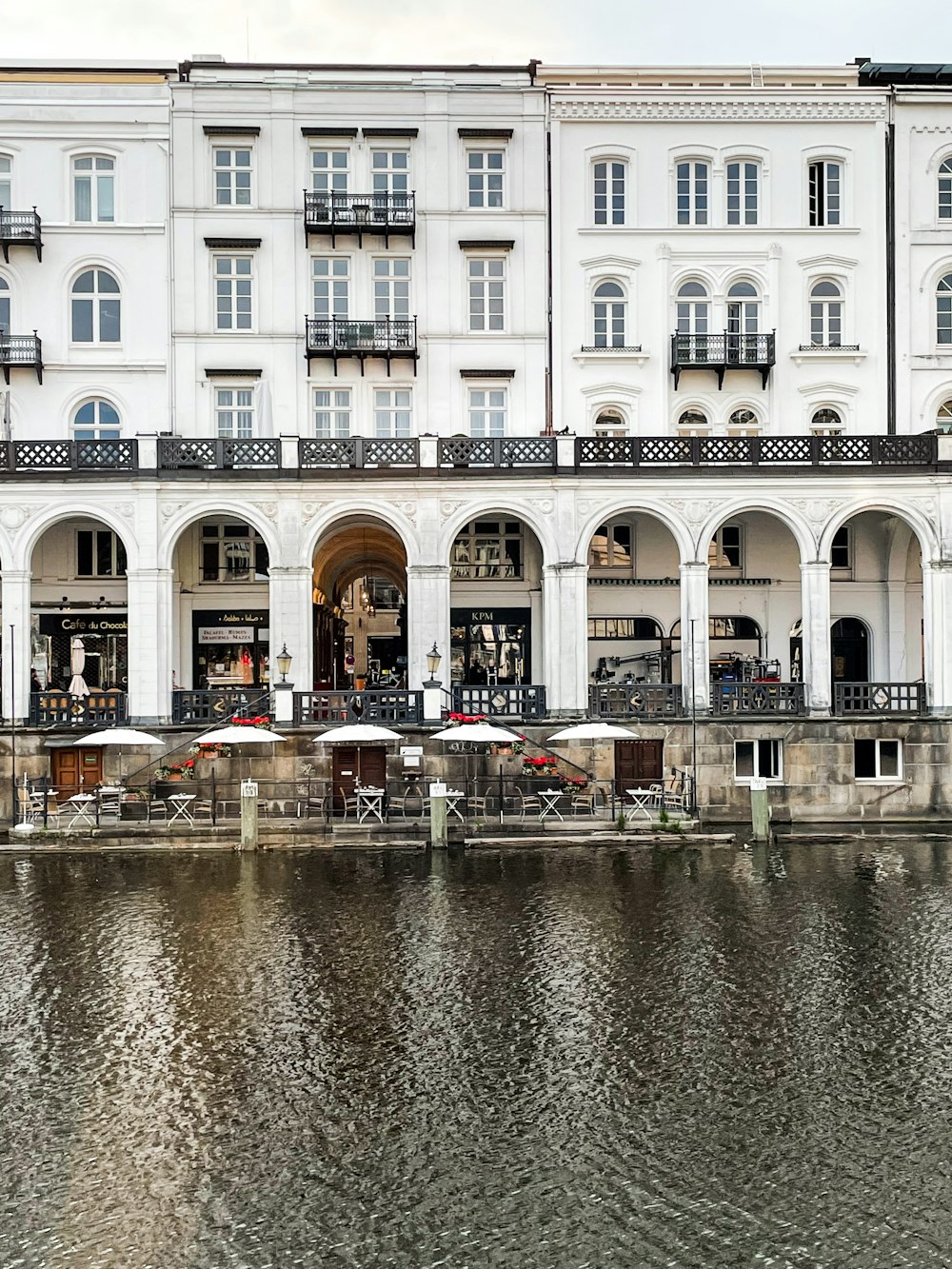 white and brown concrete building beside body of water during daytime