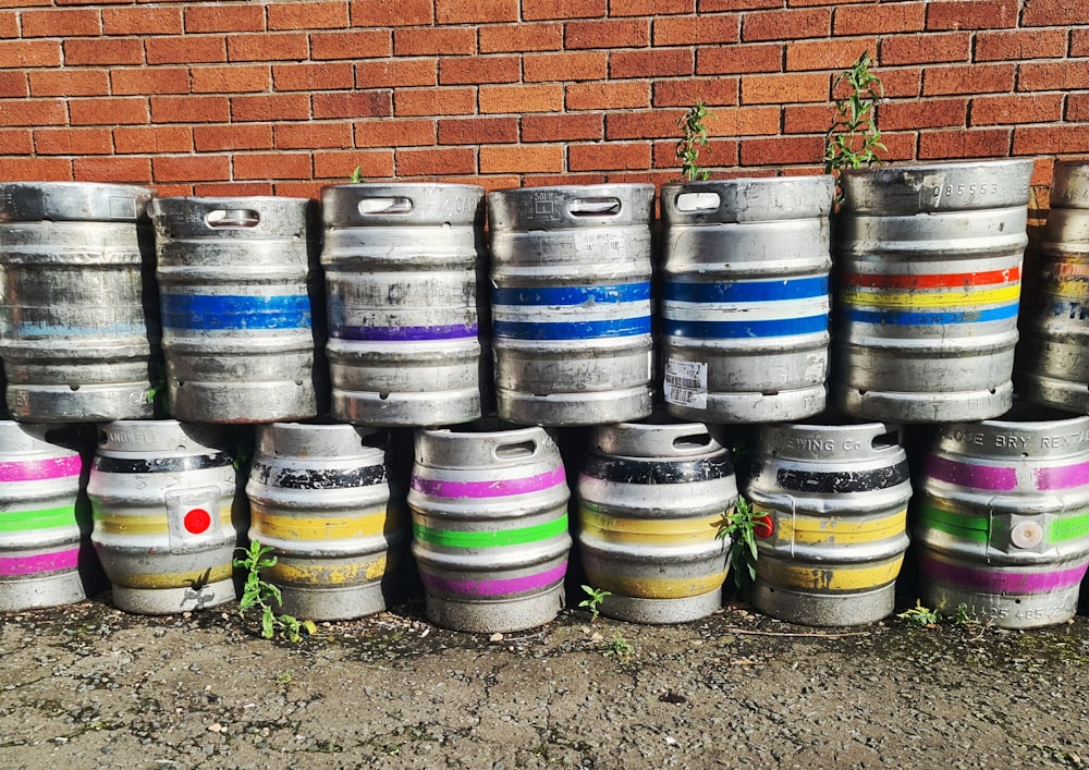 blue and white barrels beside brown brick wall