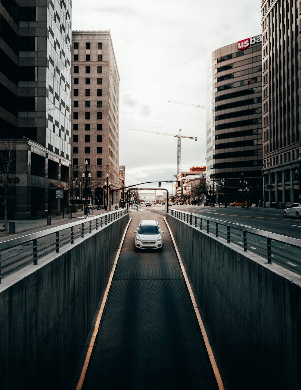 cars on road between buildings during daytime