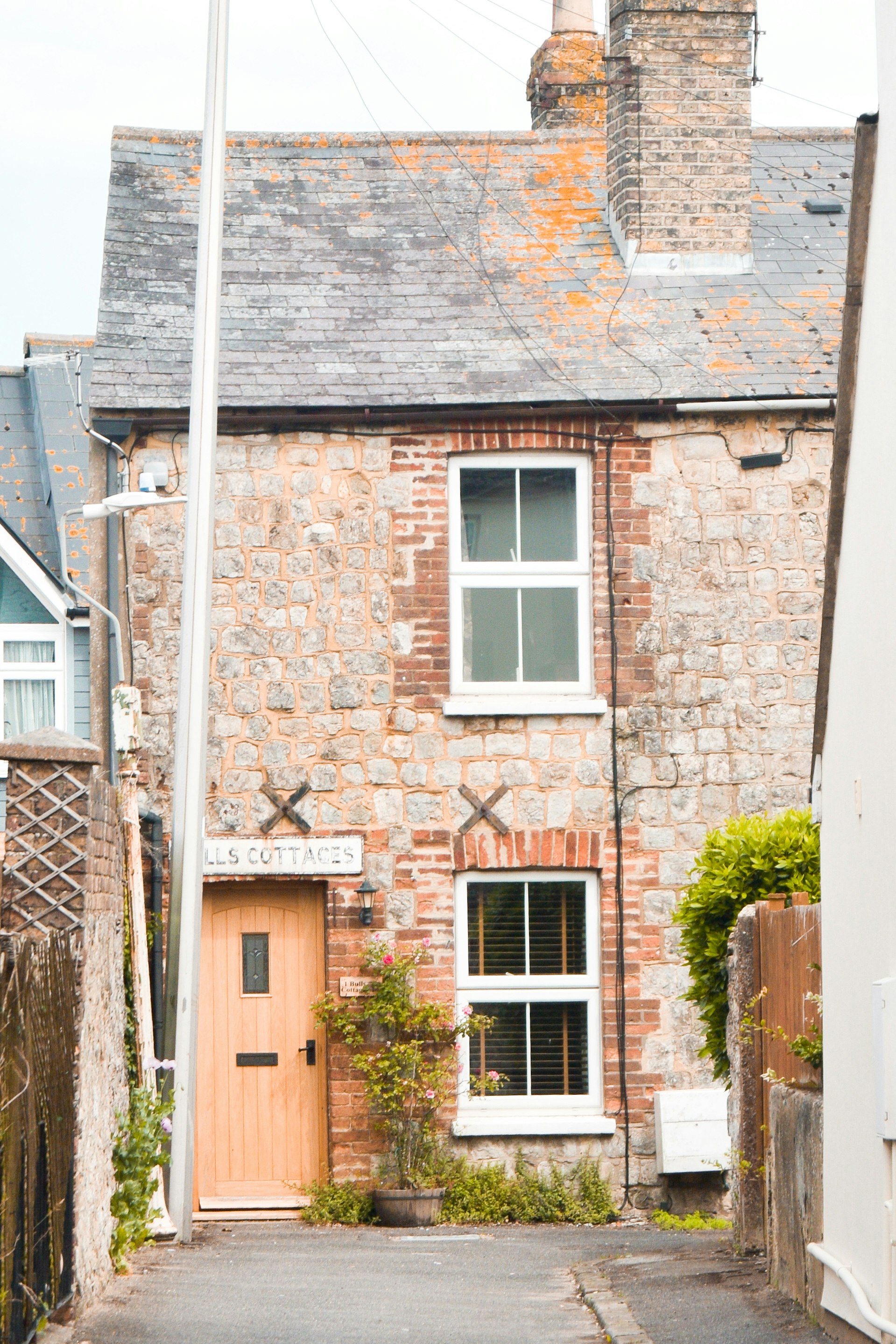 brown brick house with white wooden window