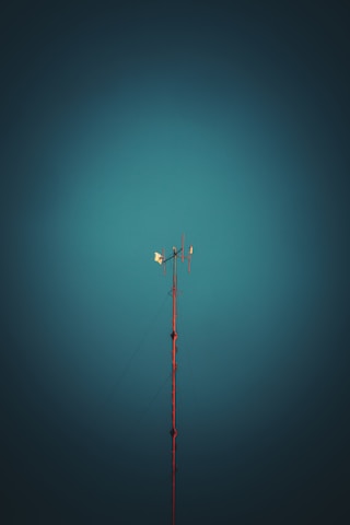 black and red metal pole under blue sky