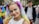 woman in white tank top with purple and yellow hair tie