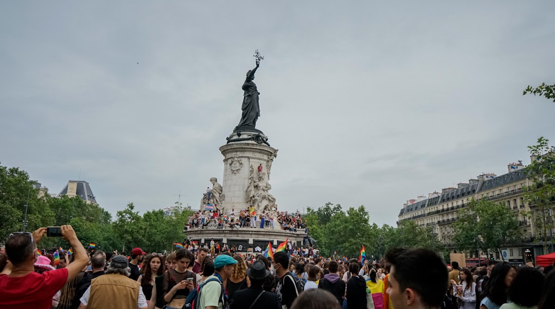 people gathering near statue during daytime