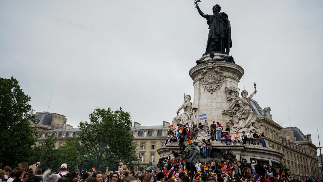 people standing near statue of man riding horse during daytime