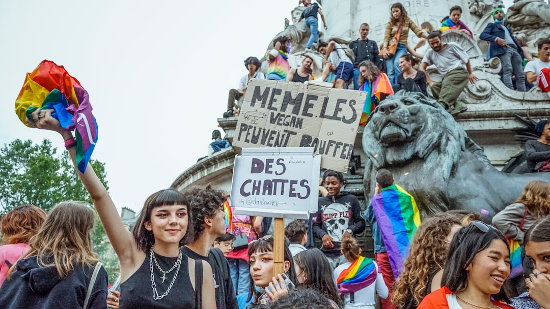 people gathering near lion statue during daytime