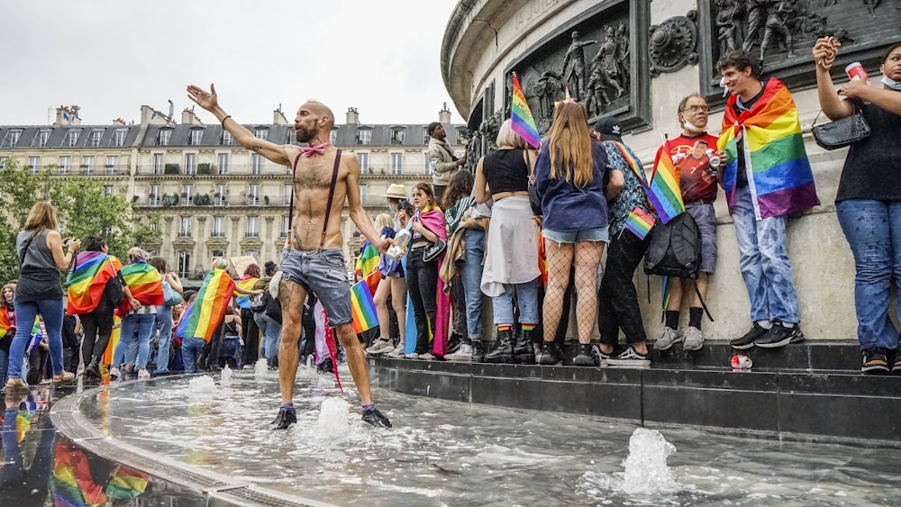 people in water fountain during daytime