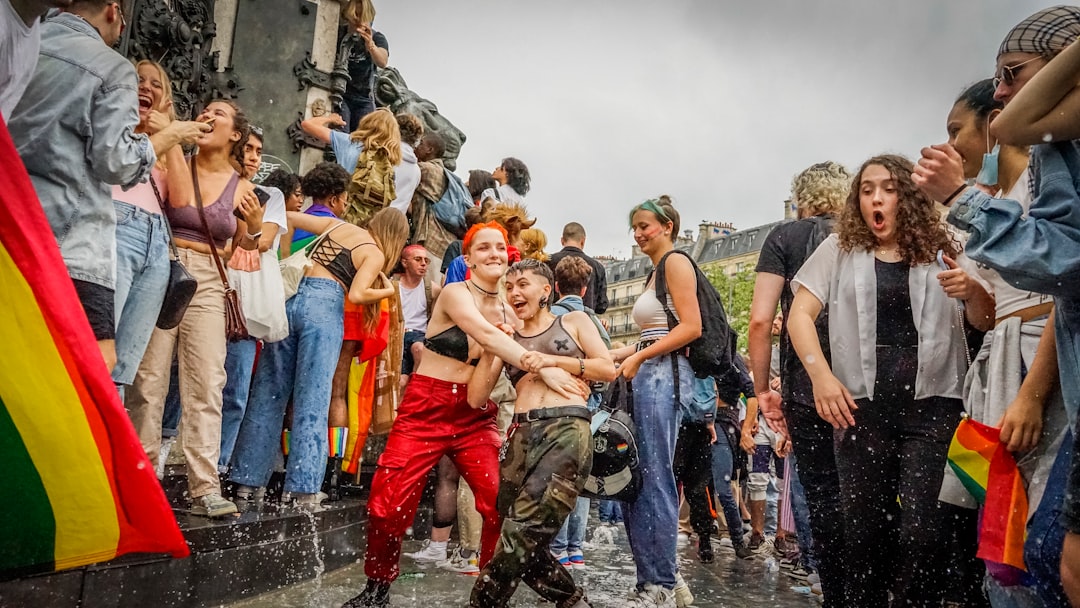 group of people standing on wet ground during daytime