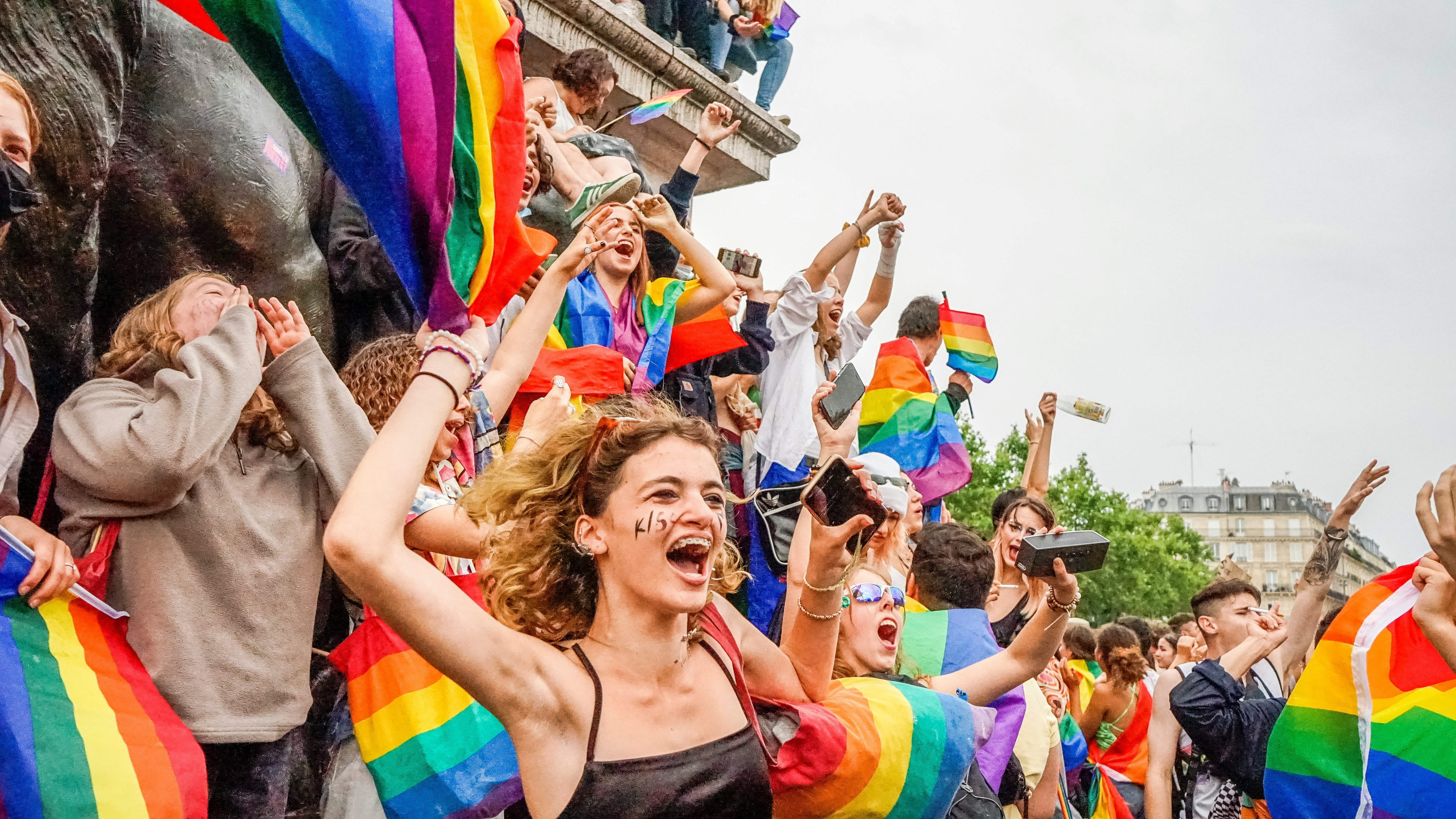 woman in red tank top raising her hands