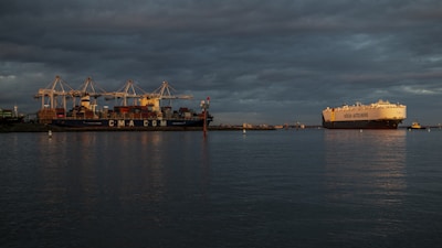 red and white cargo ship on sea during daytime