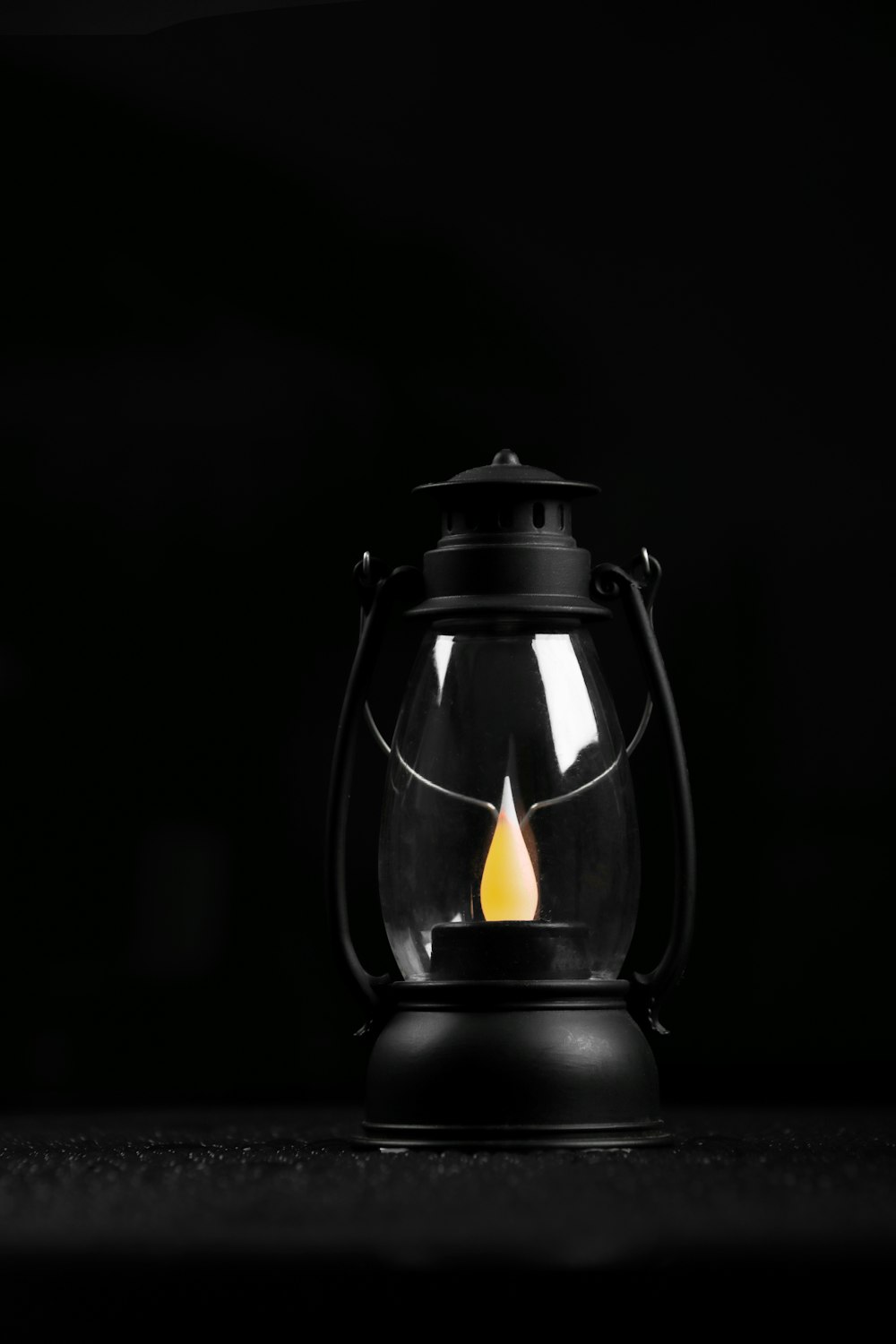 black lantern with fire in dark room
