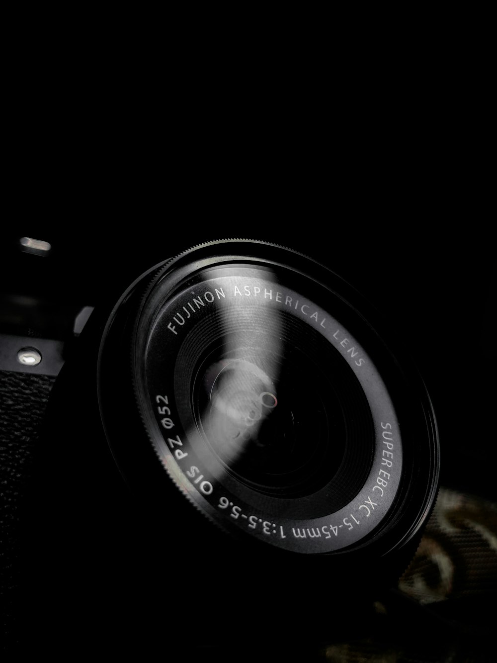 black camera lens on brown wooden table