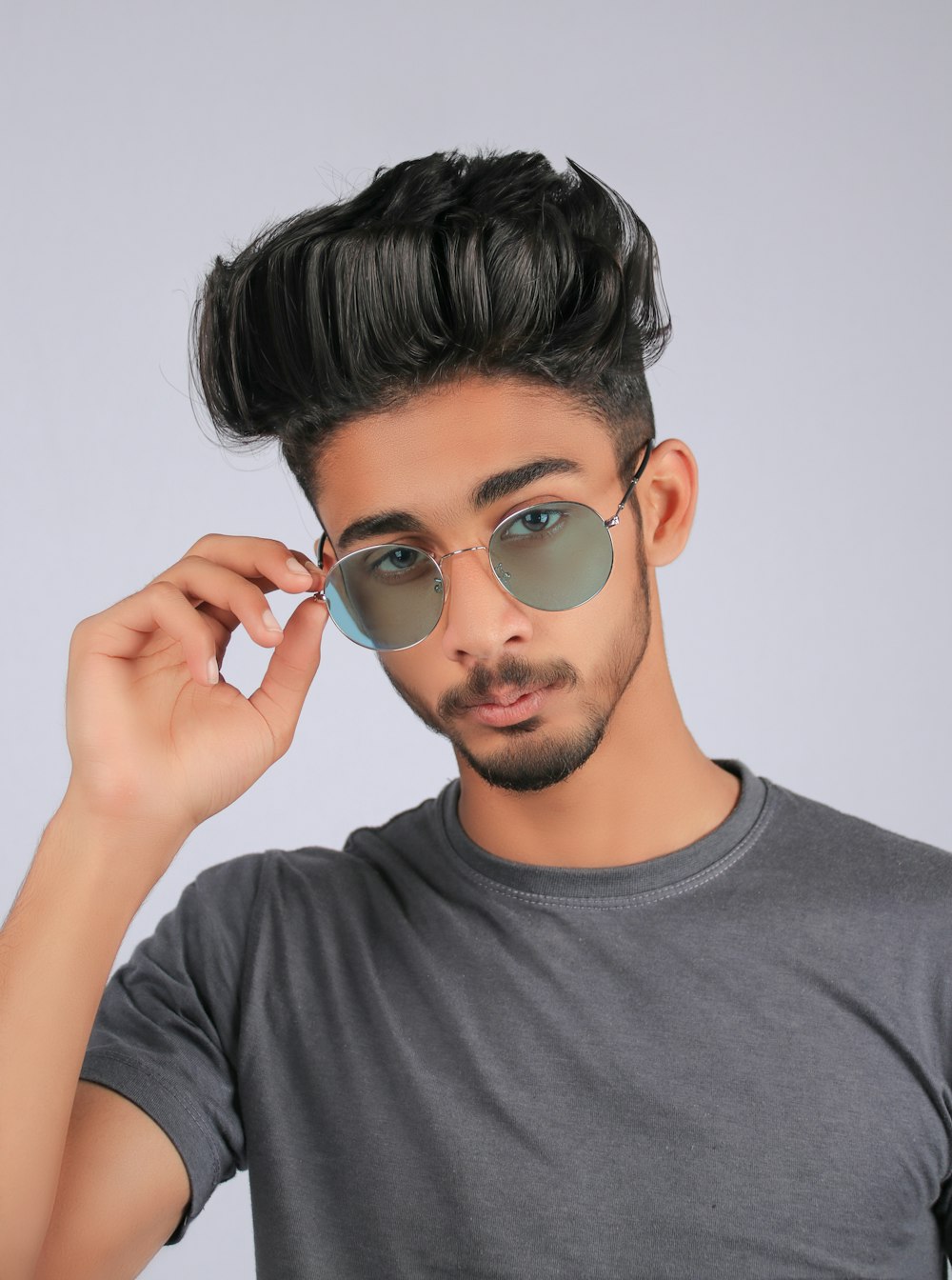 man in gray crew neck shirt wearing silver framed aviator sunglasses