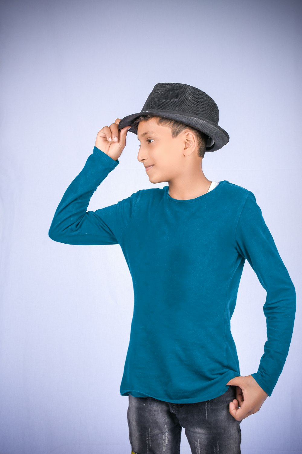 woman in blue long sleeve shirt wearing black fedora hat