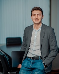 man in gray suit jacket smiling