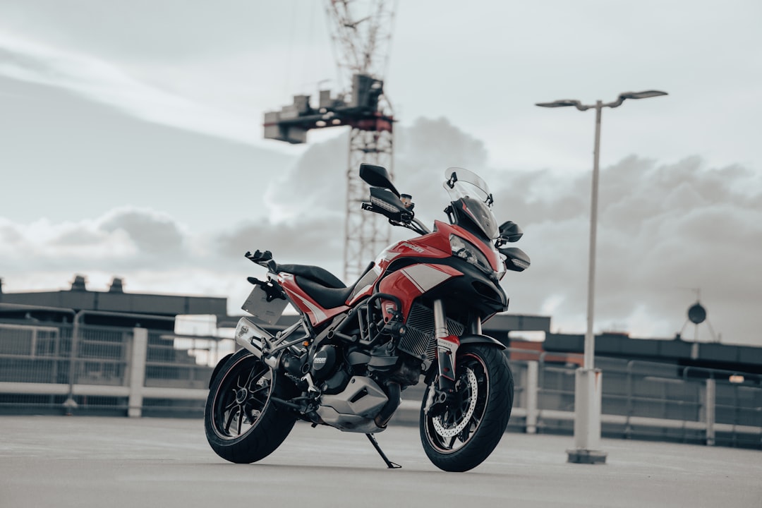 red and black sports bike on road during daytime