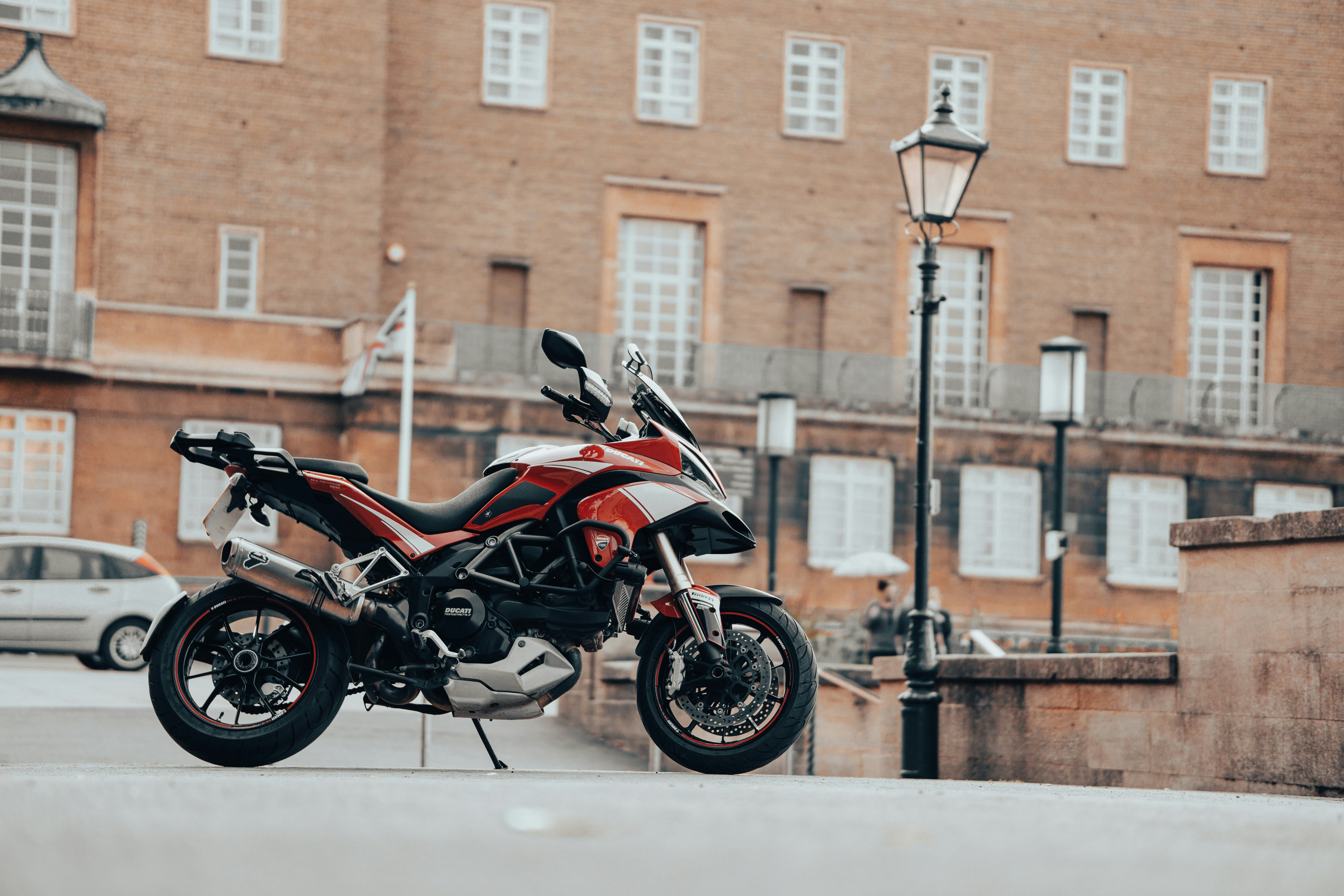 black and red naked motorcycle parked on white snow covered ground during daytime