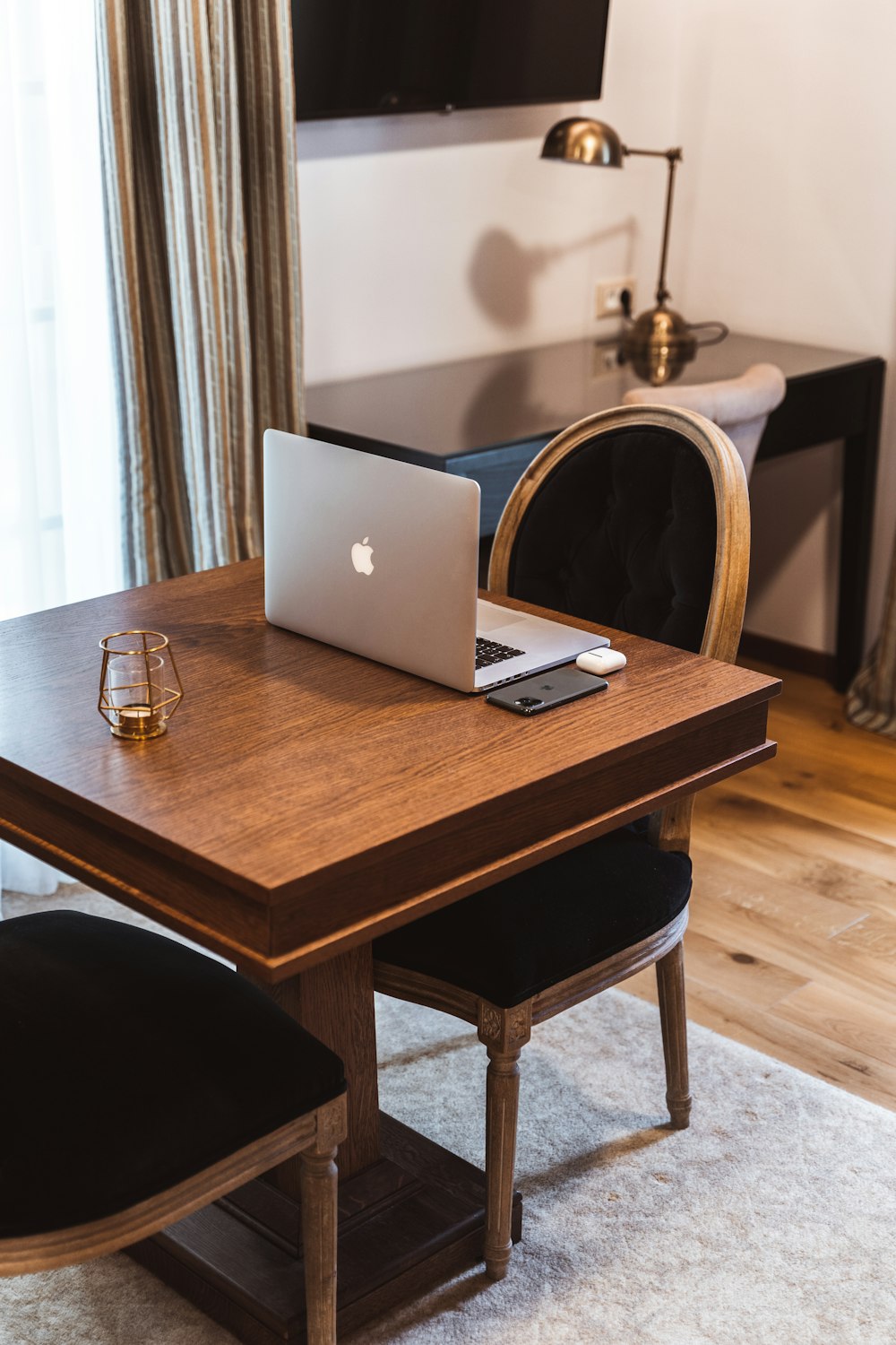 silver macbook on brown wooden table