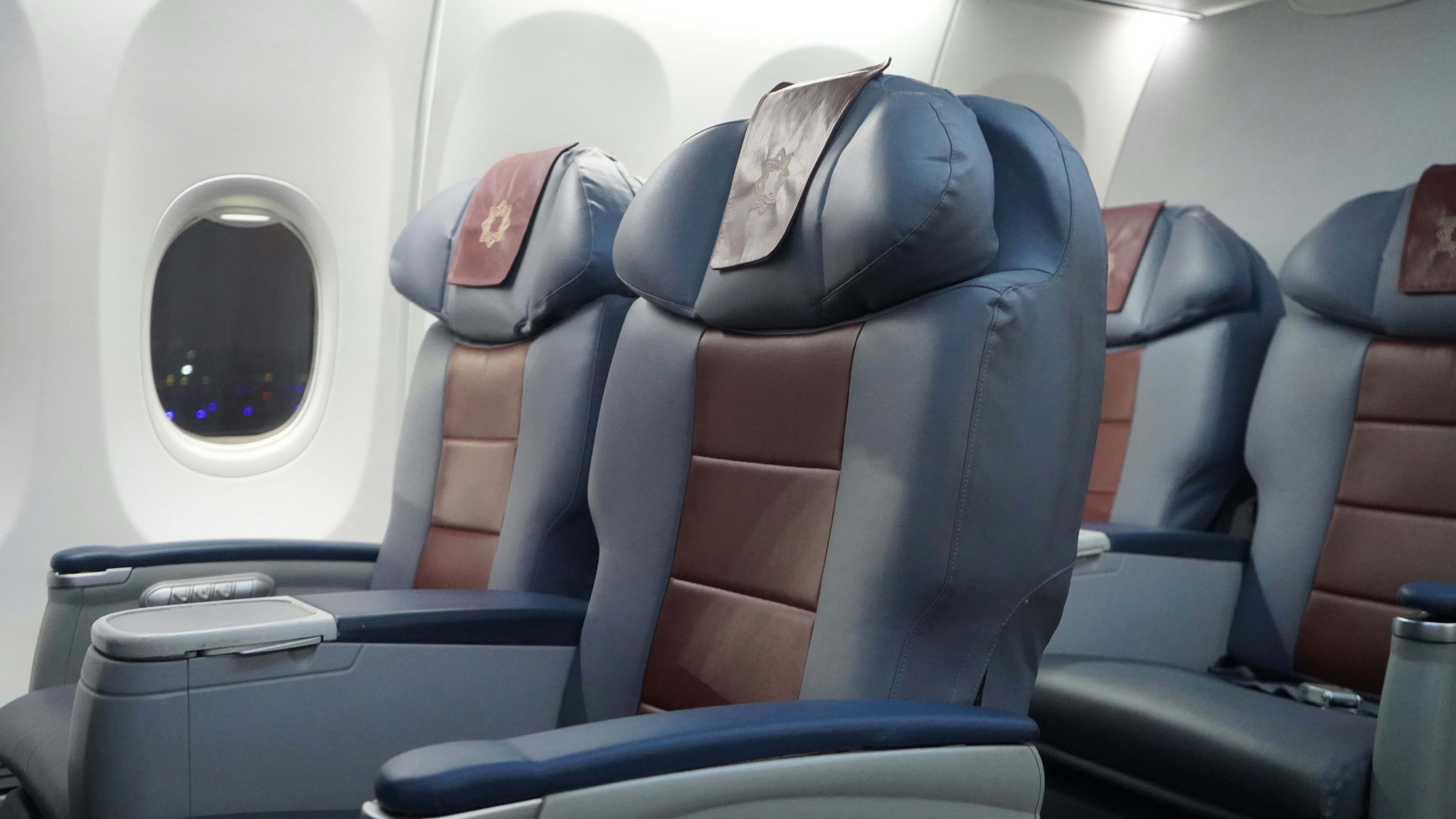 black and brown leather padded chair, Business class seats in a Boeing 737 aeroplane.