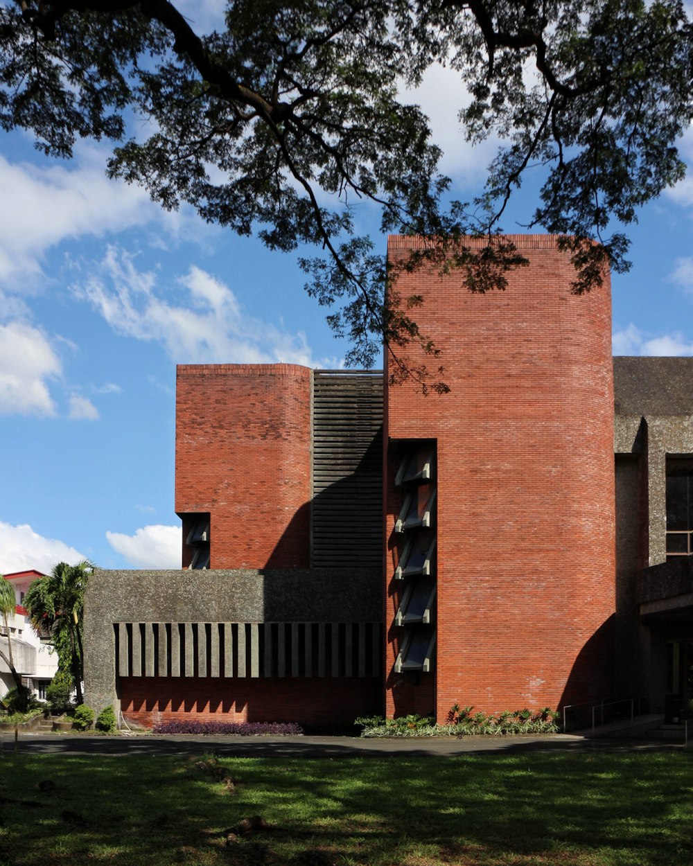 brown brick building near green grass field during daytime