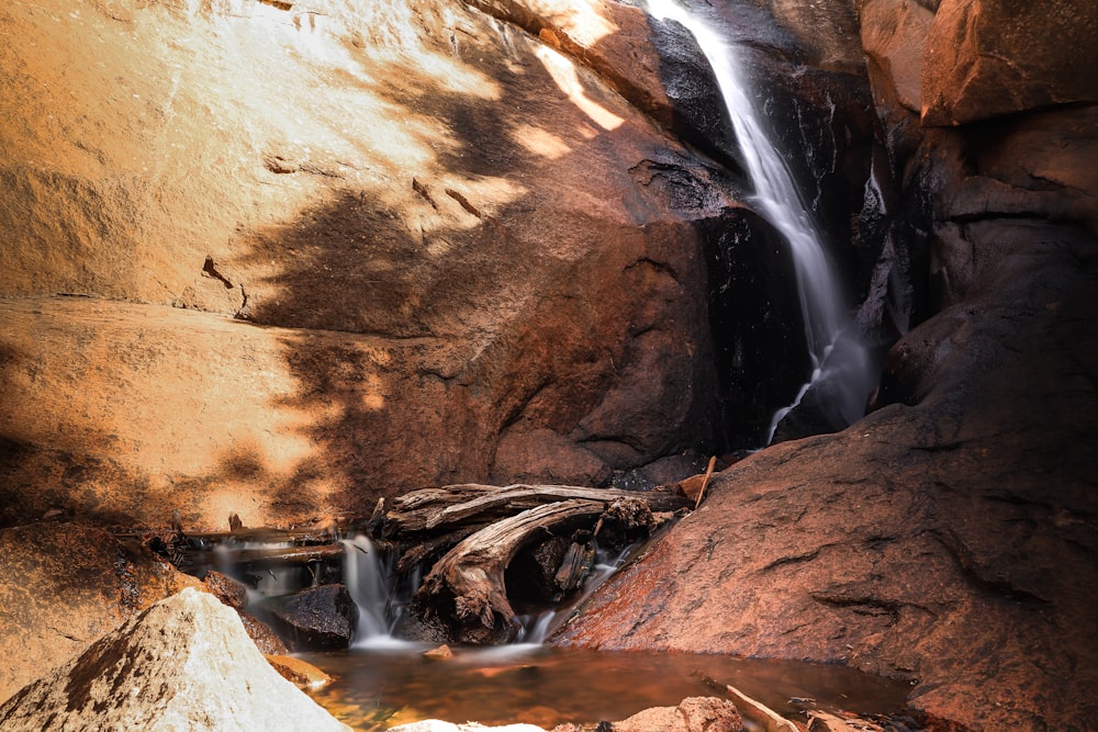 water falls on brown rock