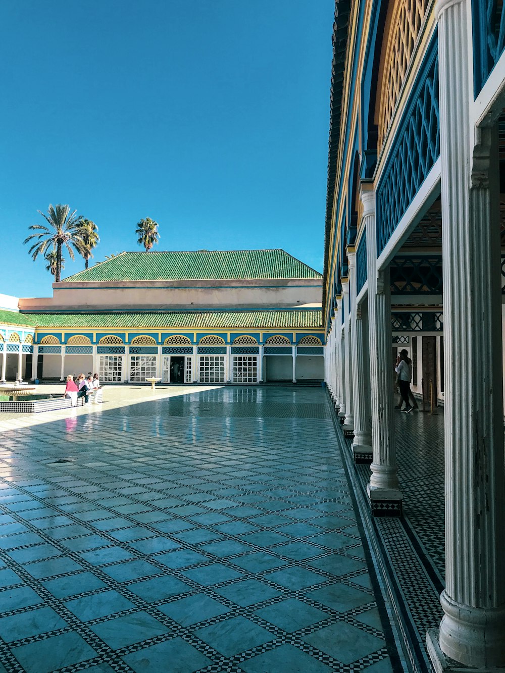 people walking on sidewalk near building during daytime