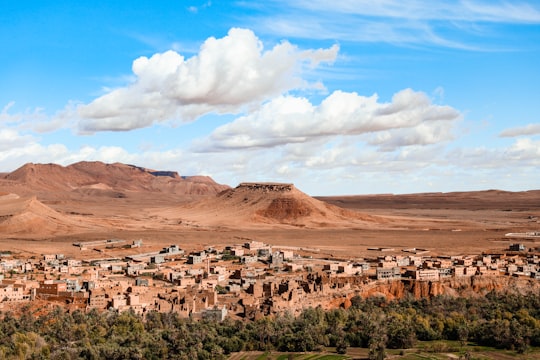 green trees and brown mountains under blue sky and white clouds during daytime in Tinghir Morocco