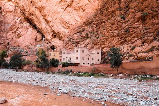 white concrete building near brown rocky mountain during daytime in Dadès Gorges Morocco