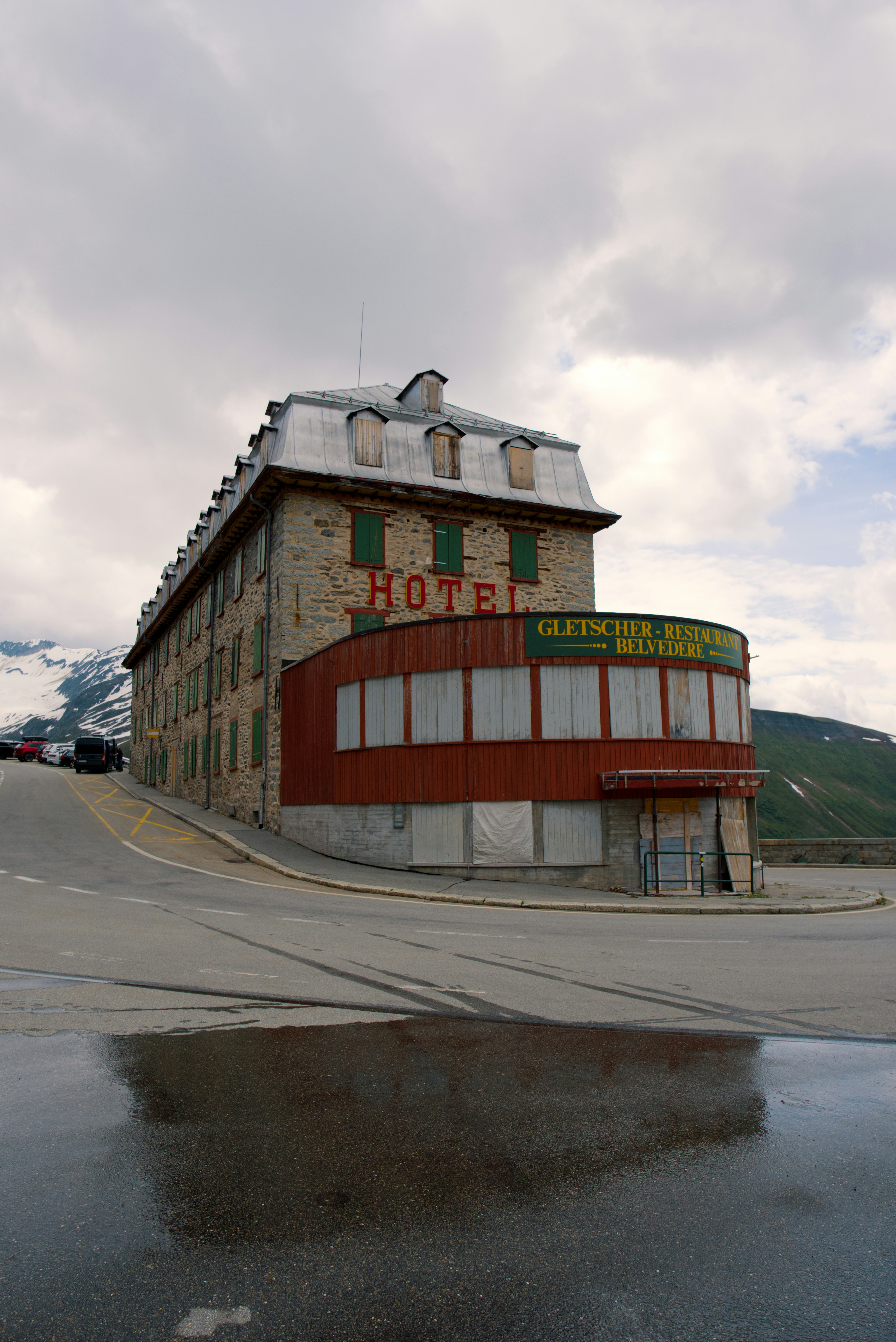 red and brown wooden building on gray sand during daytime