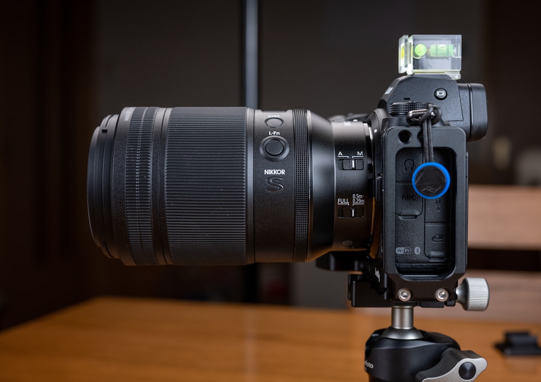 black nikon dslr camera on brown wooden table