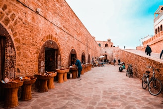 people walking on brown brick building during daytime
