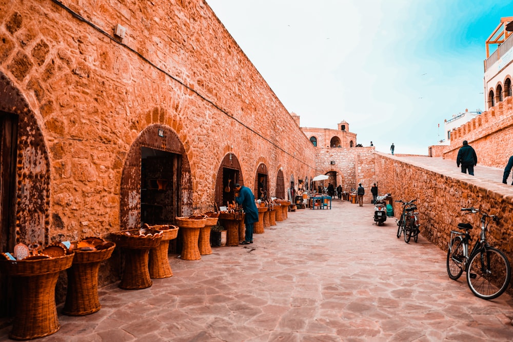 people walking on brown brick building during daytime