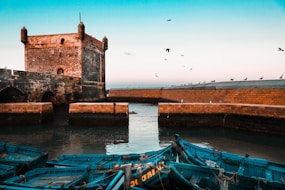 brown brick building near body of water during daytime