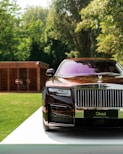 black and silver rolls royce on premium tires parked on green grass in Nigeria during daytime