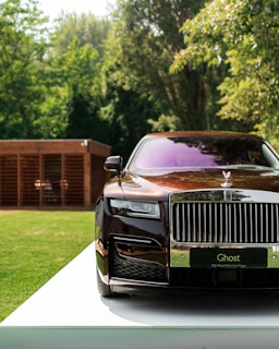black and silver rolls royce on premium tires parked on green grass in Nigeria during daytime