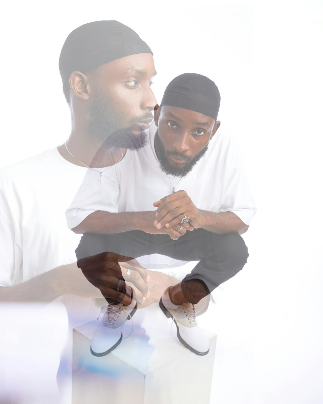 man in white thobe sitting beside man in white thobe