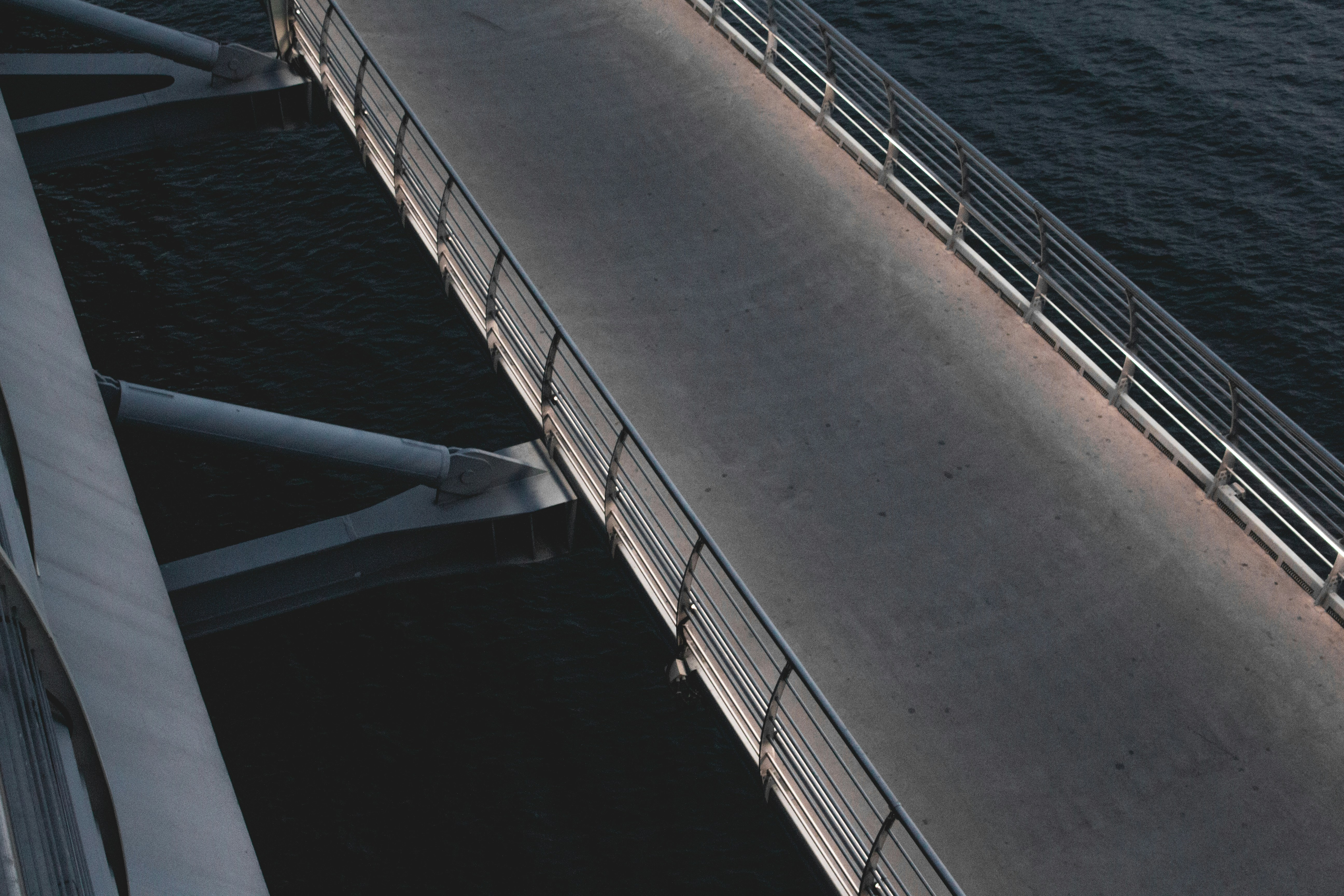 white metal bridge over the sea