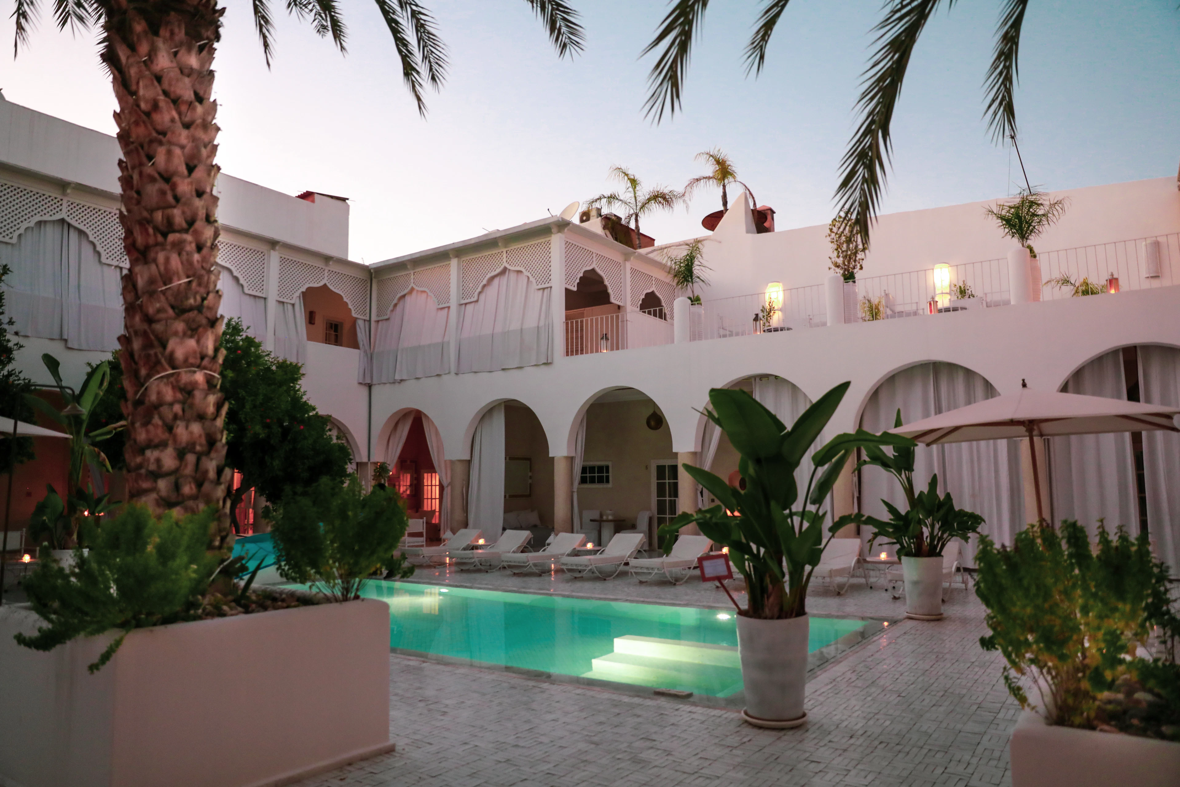 A white courtyard and palms in Marrakech