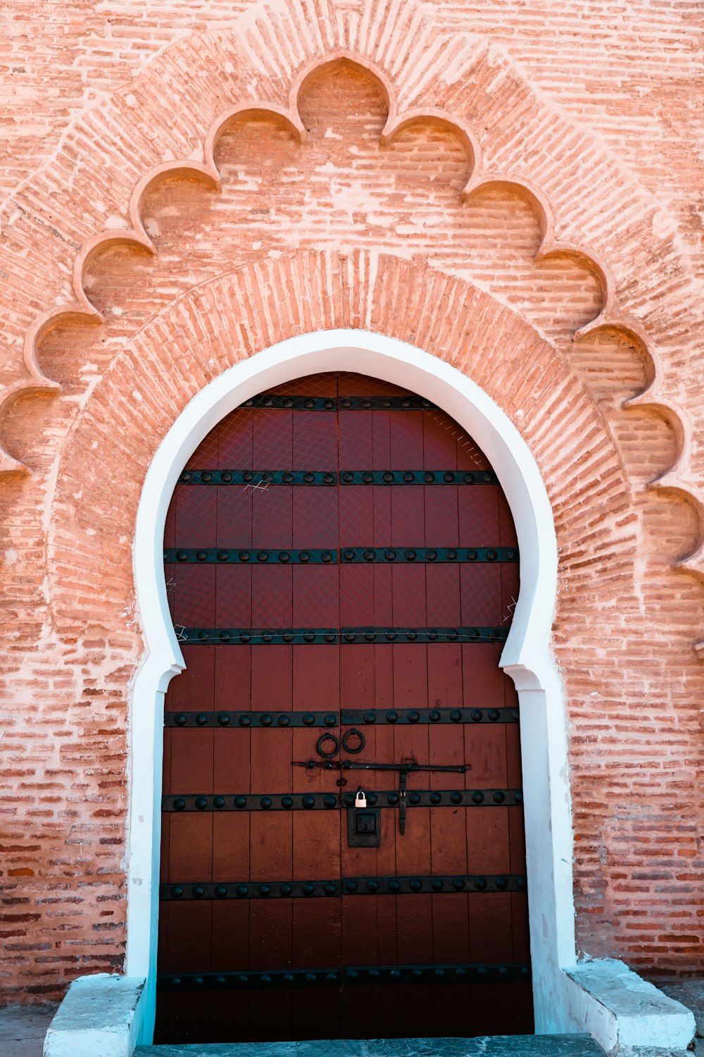 brown wooden door on brown brick wall