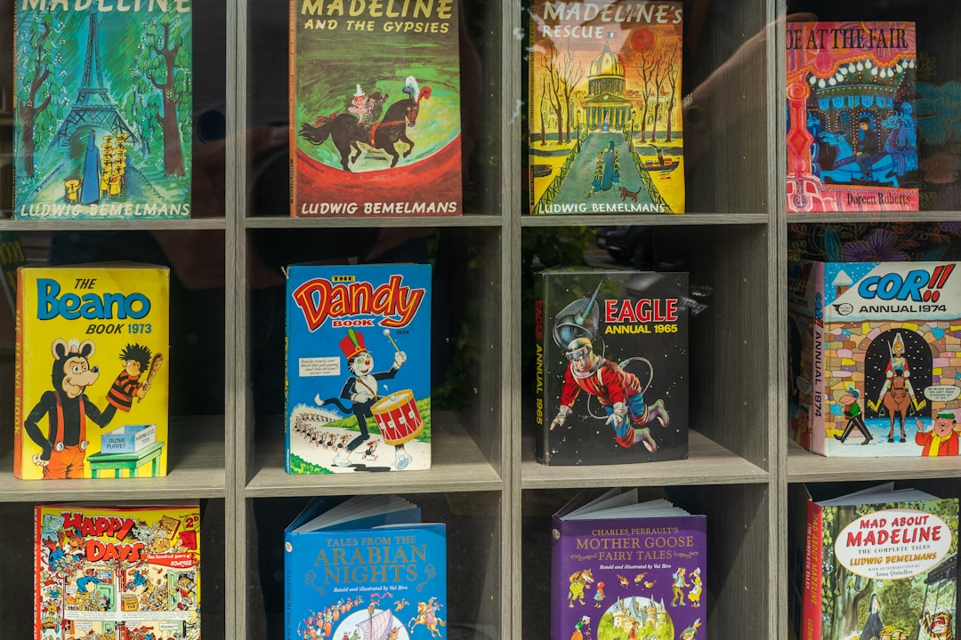 assorted books on blue wooden shelf