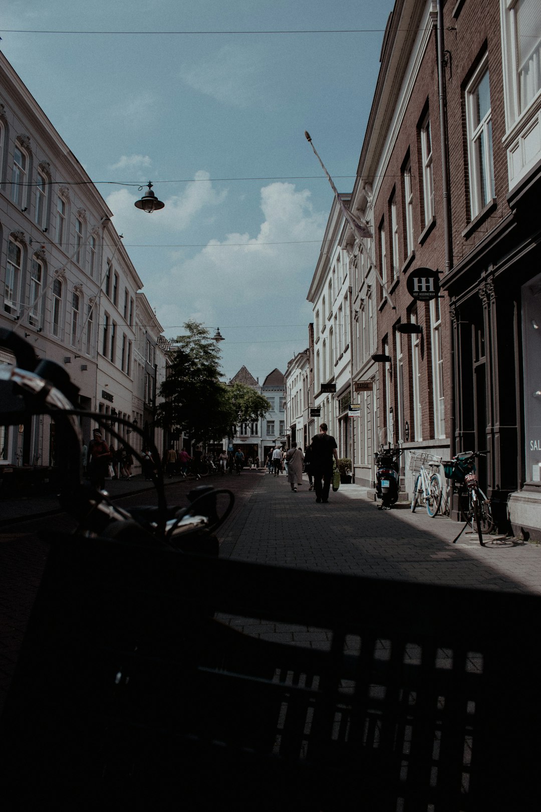 people walking on sidewalk near buildings during daytime