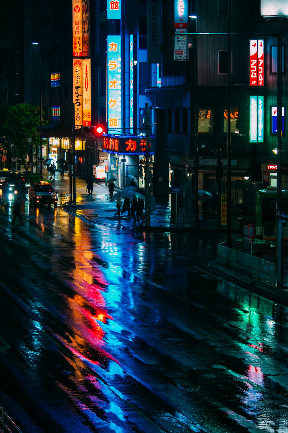 people walking on sidewalk near building during night time