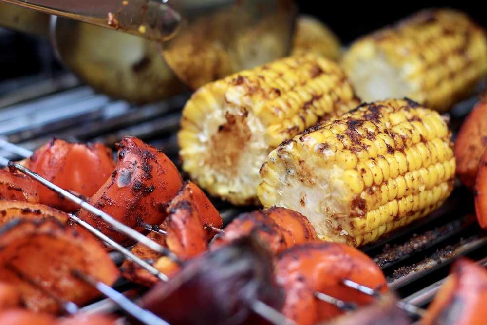 grilled corn on stick with red sauce