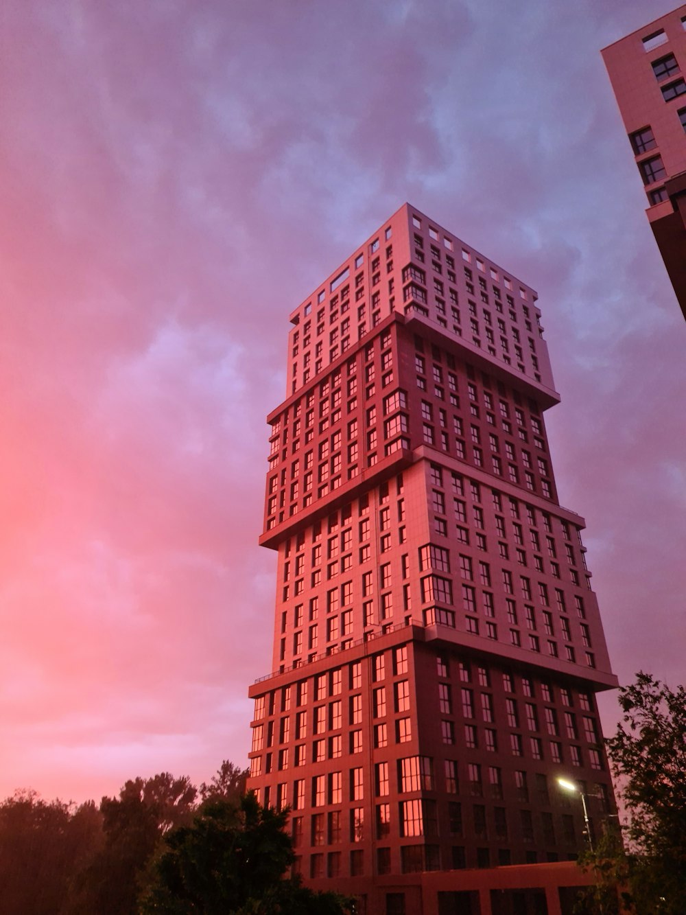 brown concrete building under cloudy sky during daytime