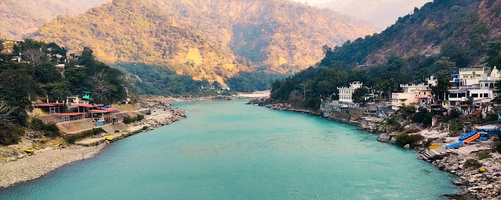 green and brown mountains beside body of water during daytime