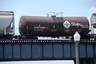 black and brown train on rail tracks during daytime