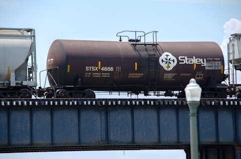 black and brown train on rail tracks during daytime