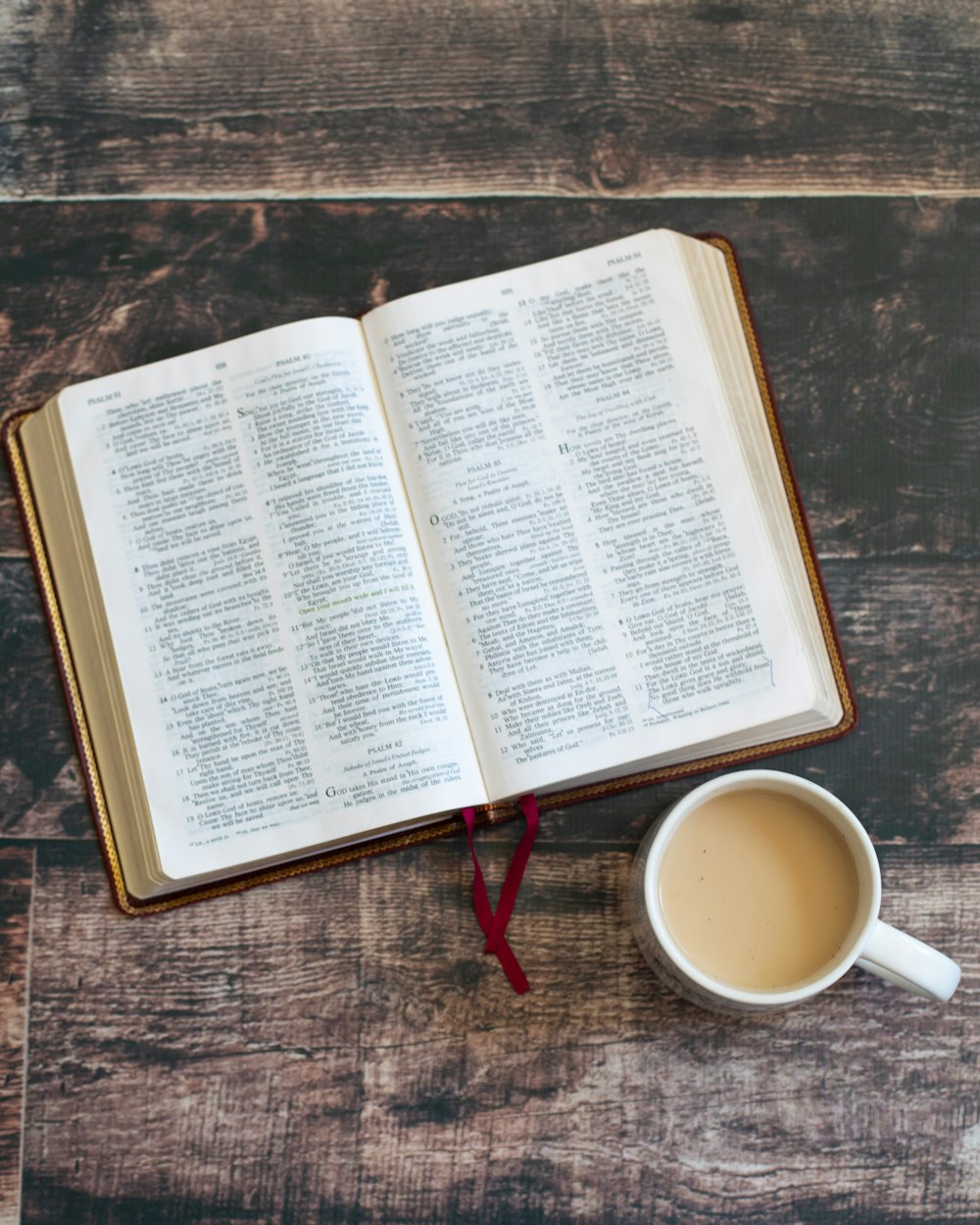 white book page beside white ceramic mug