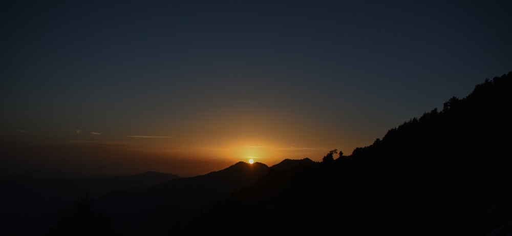 silhouette of mountain during sunset