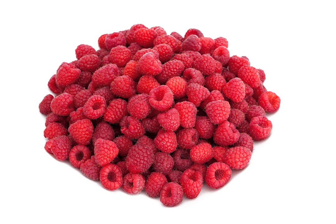 red raspberries on white background