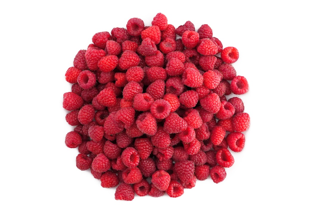 red raspberries on white background